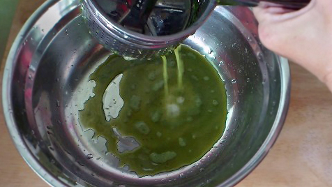 squeezing juice from minced pandan leaves