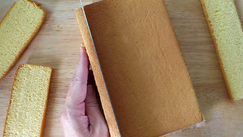 cutting castella cake to show fine crumb structure